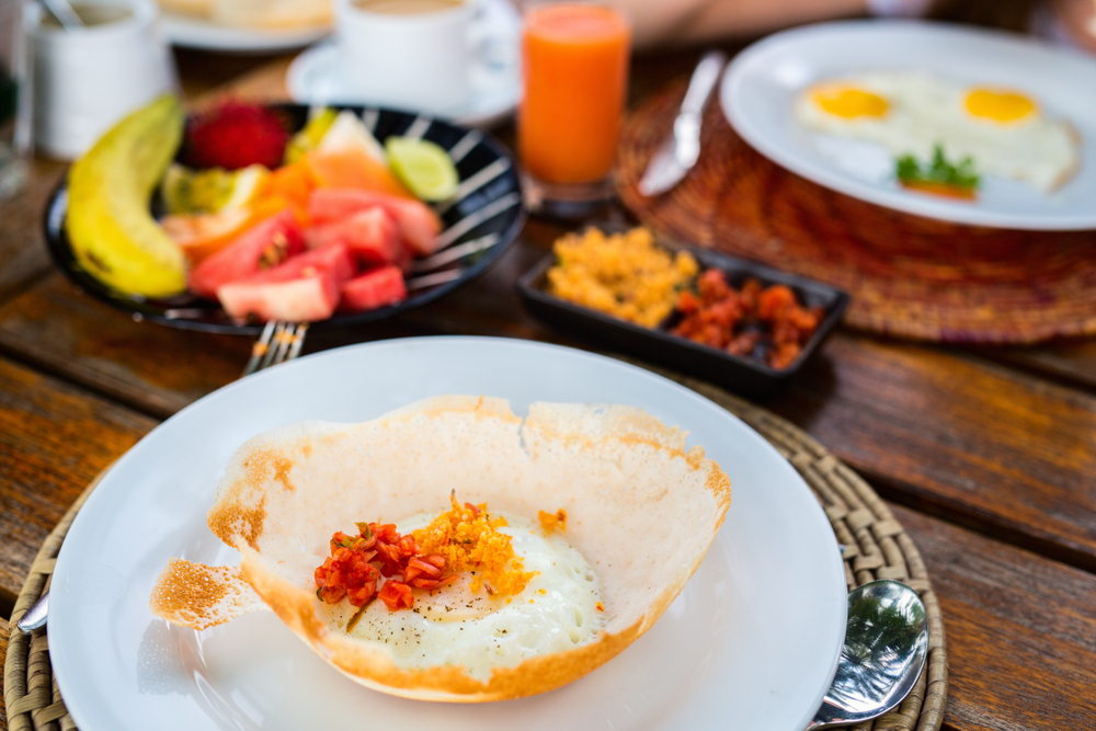 Traditional Sri Lankan breakfast with egg hoppers and lunu miris