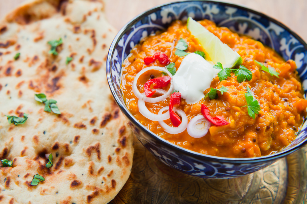 A dish of Dhal next to Roti